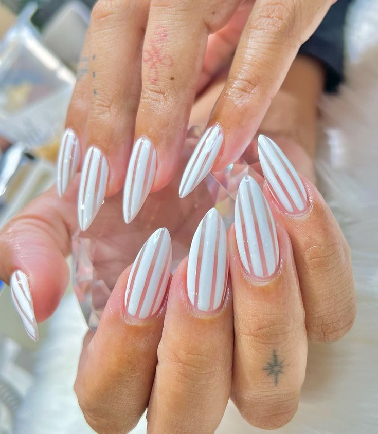 Chic Almond-Shaped Nails: Glossy White and Delicate Pink Stripes for a Stylish Look.