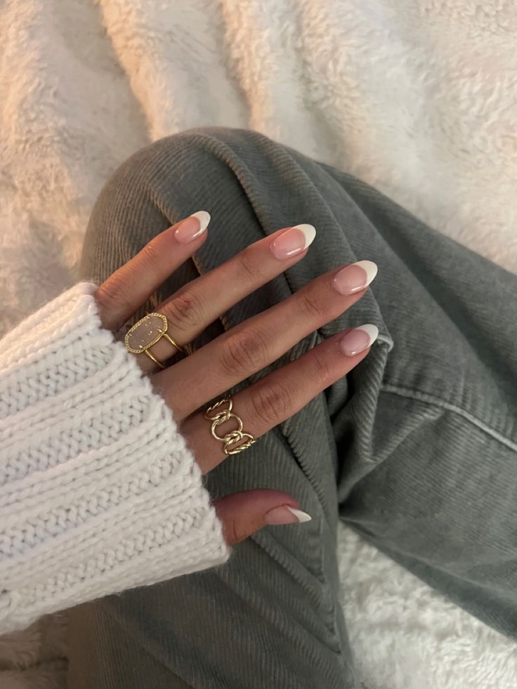 Chic French Manicure with Soft Pink and White Tips, Perfectly Complementing Casual Knit and Denim Styles.