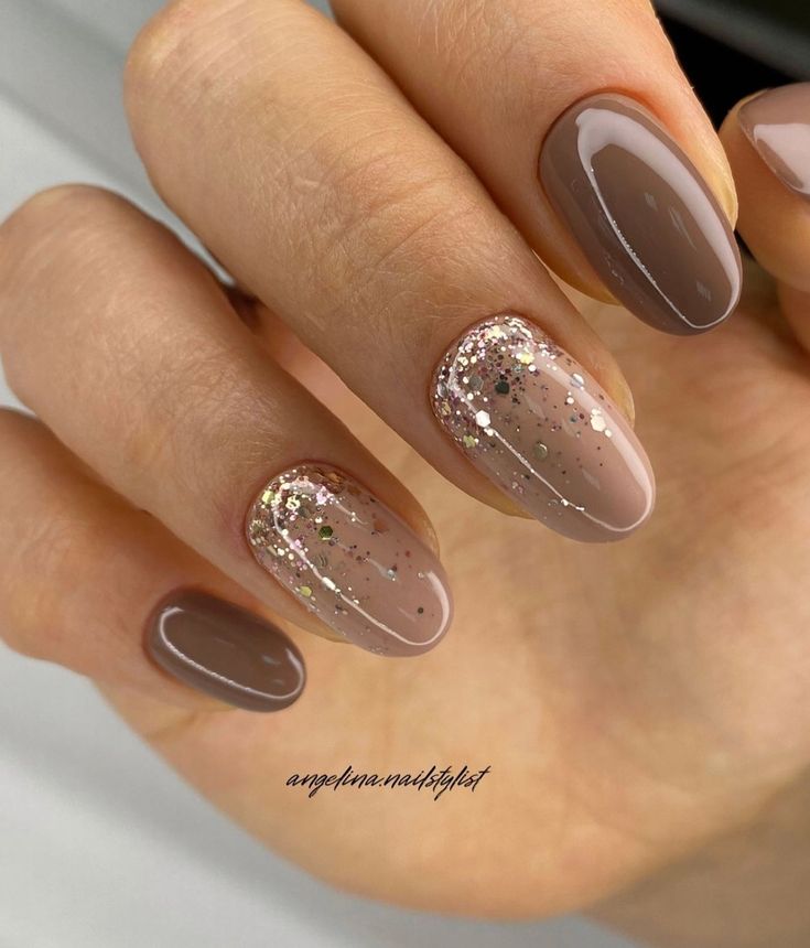 Elegant Brown and Beige Manicure with Glamorous Glitter Accents.