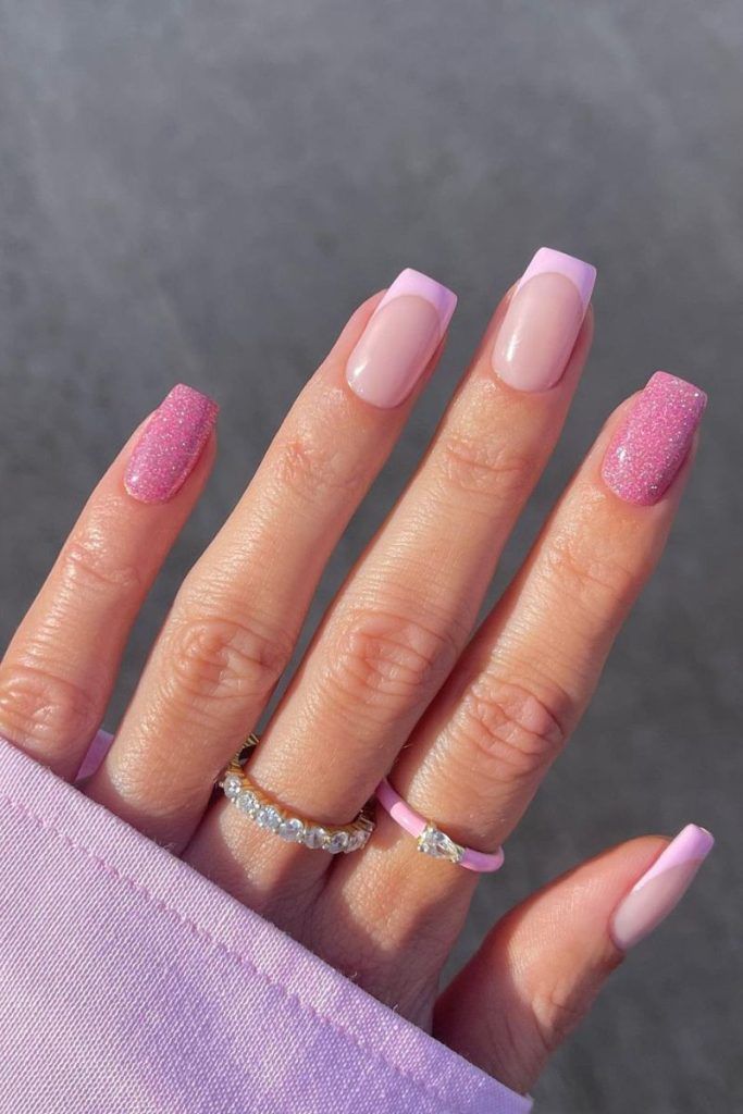 Chic Soft Pink Nail Design with Glitter Accents for a Trendy Look.