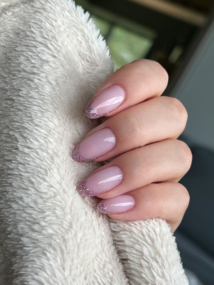 Elegant Soft Pink Nail Design with Glitter Accents for Everyday and Special Occasions.