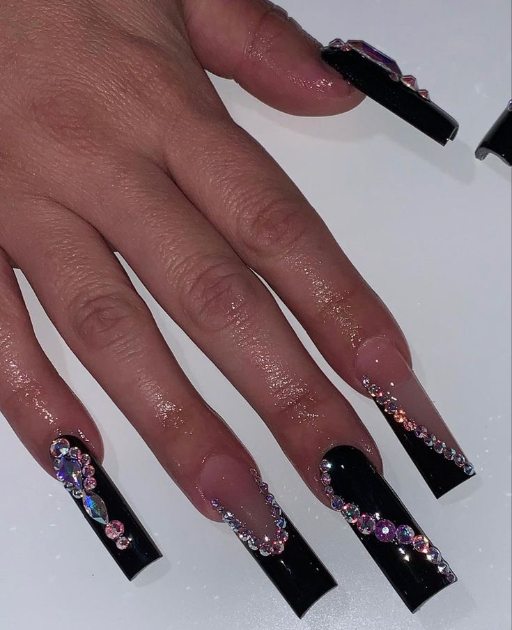 Elegant Black Stiletto Nails Embellished with Sparkling Gemstones