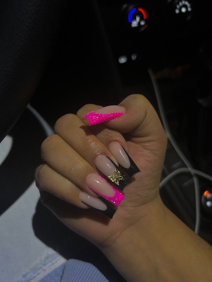 Bold and Elegant Nail Design: Vibrant Pink Glitter and Sleek Black Accents on a Soft Nude Base.