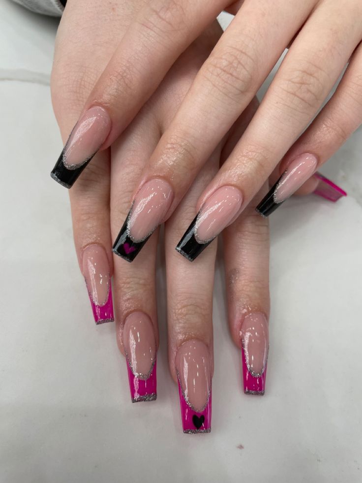 Chic Black and Pink Nail Design with Heart Motifs and Glitter Accents.