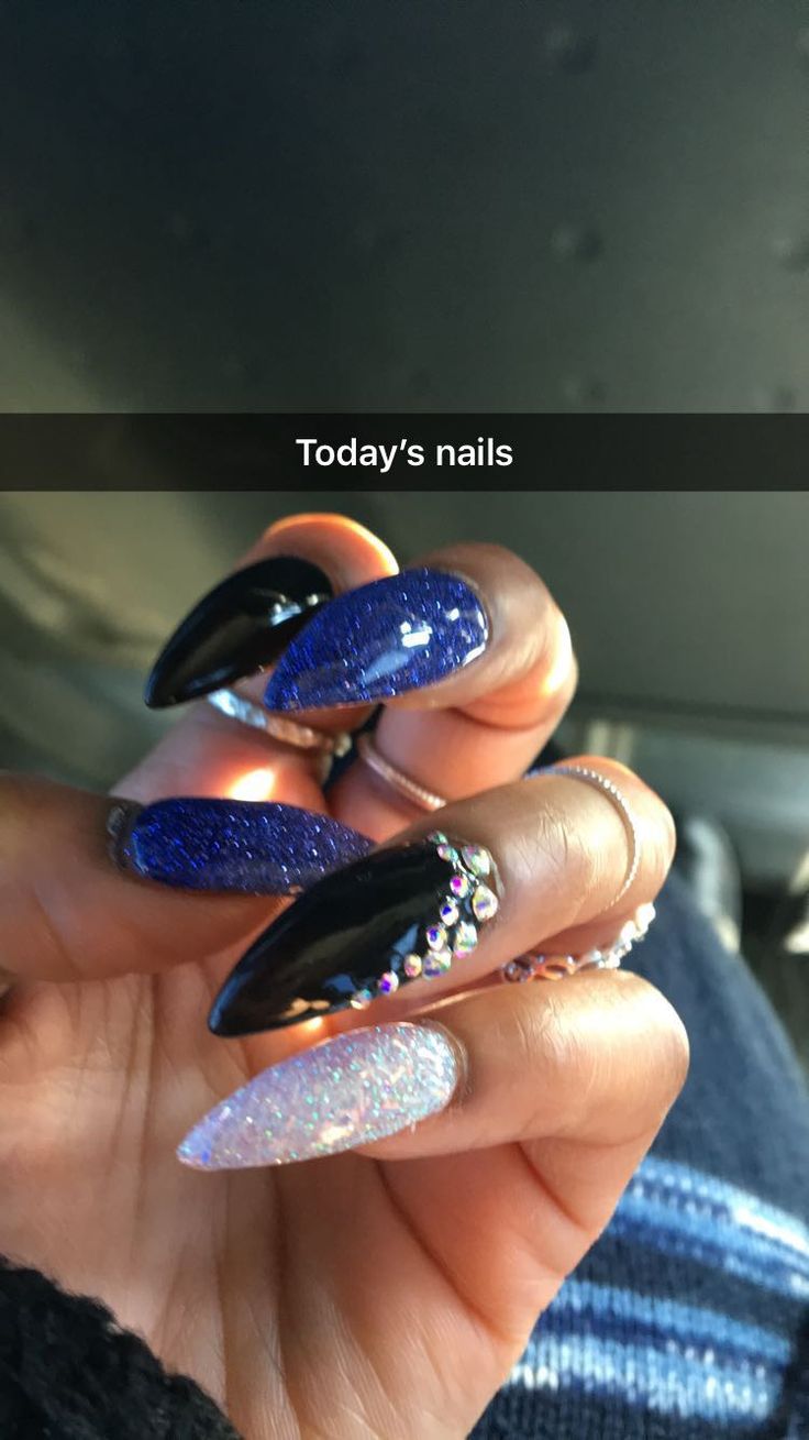 Glamorous Nail Design: Glossy Black and Deep Blue with Iridescent Glitter and Rhinestone Accents