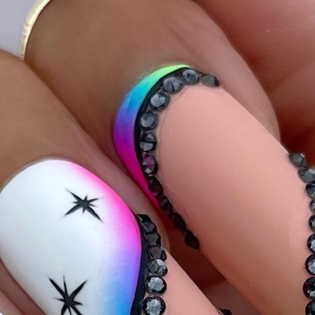 Chic Colorful Gradient Nails with Black Accents and Sparkling Embellishments.