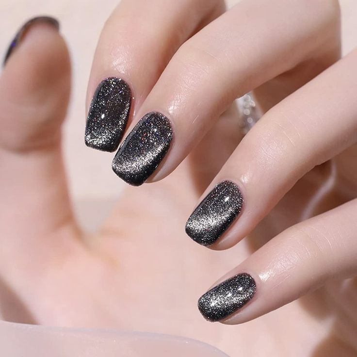 Glistening Black and Silver Gradient Nail Design: Elegant Glamour for Any Occasion.