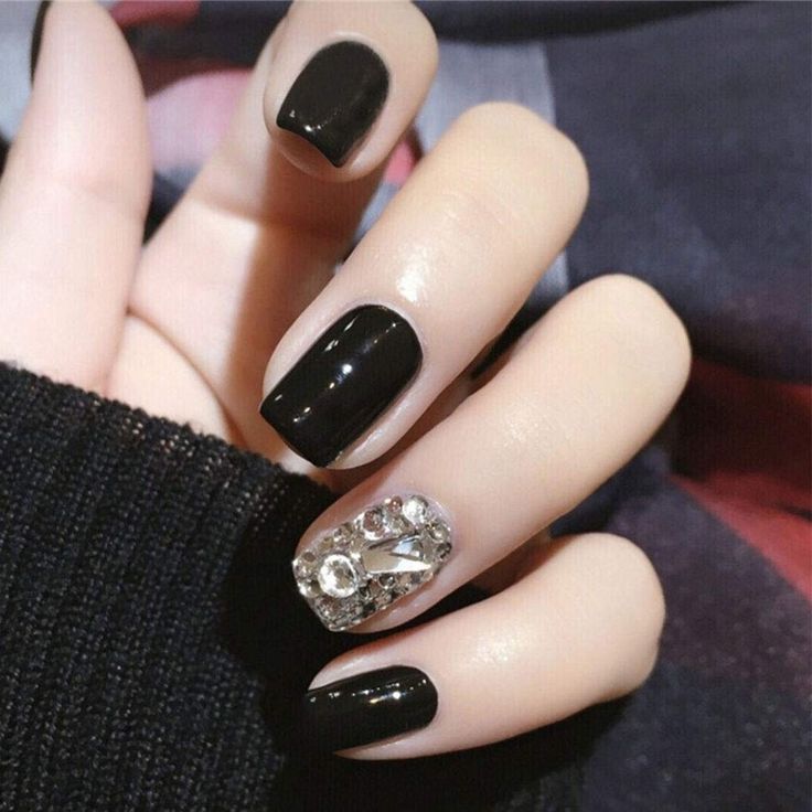 Chic Nail Design: Glossy Black Polish with Sparkling Rhinestone Accent