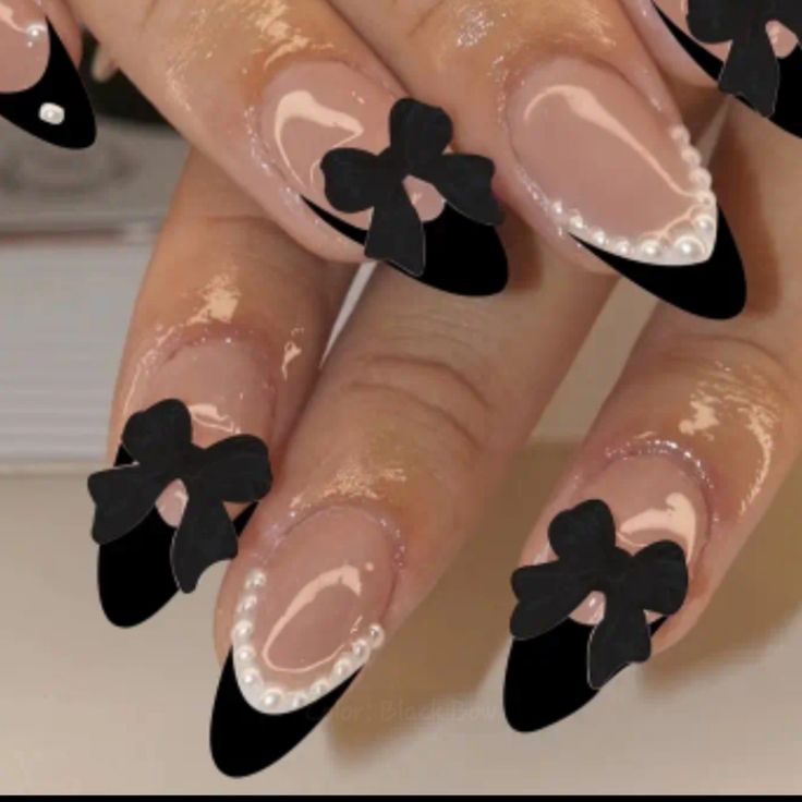 Chic Nude Nails with Black Tips, Bow Accents, and Pearl Details