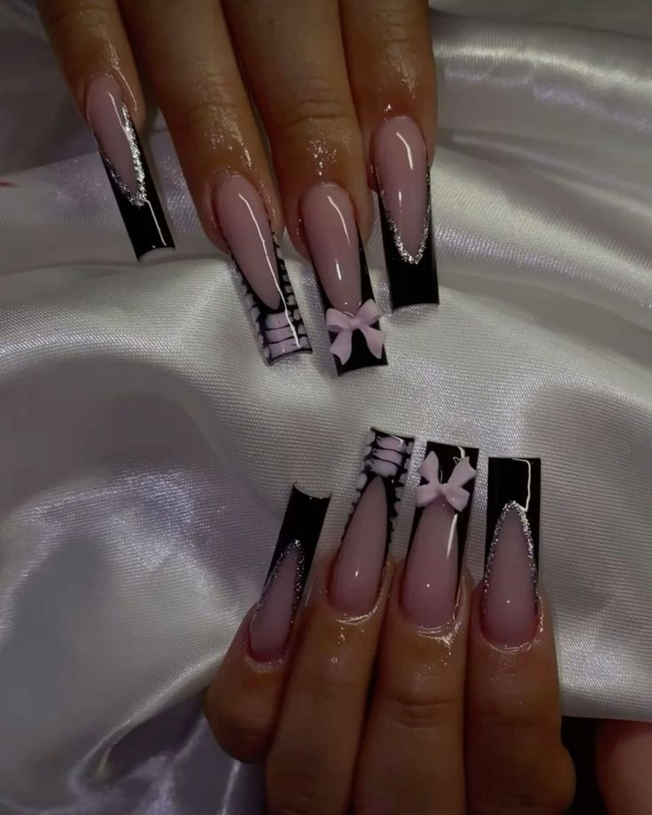 Elegant Tapered Nail Design: Glossy Black and Soft Pink with Silver Accents and Bows.