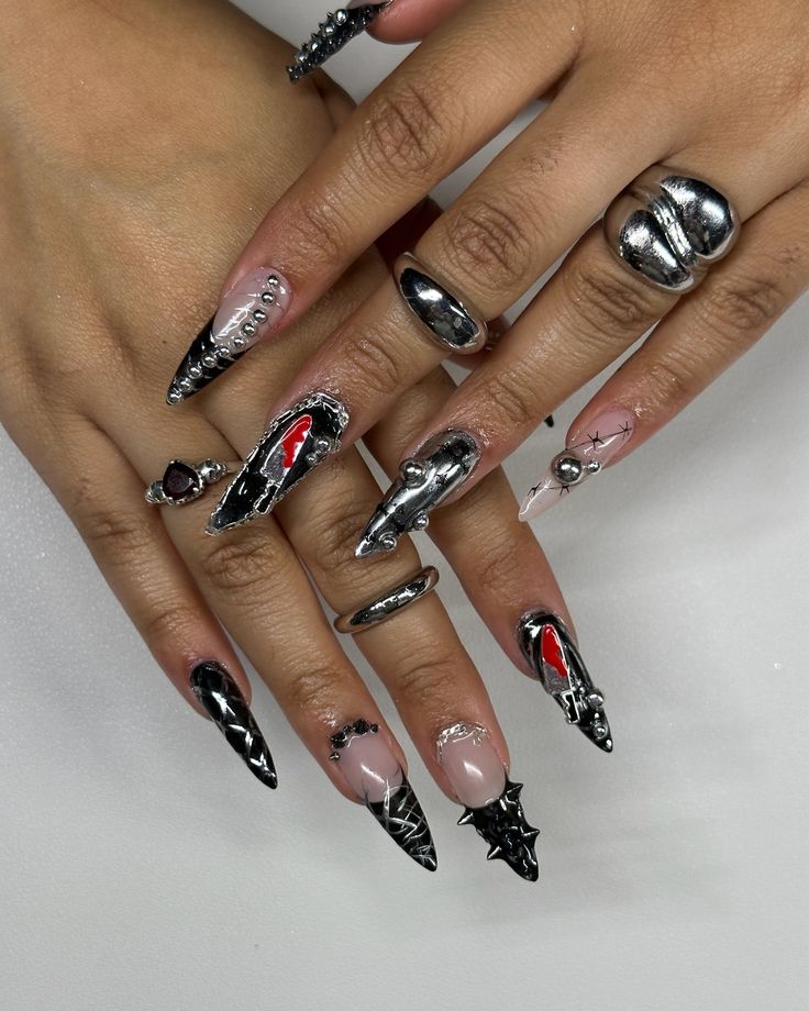 Daring Stiletto Nail Art: Intricate Black and Silver Design with Glamorous Accents