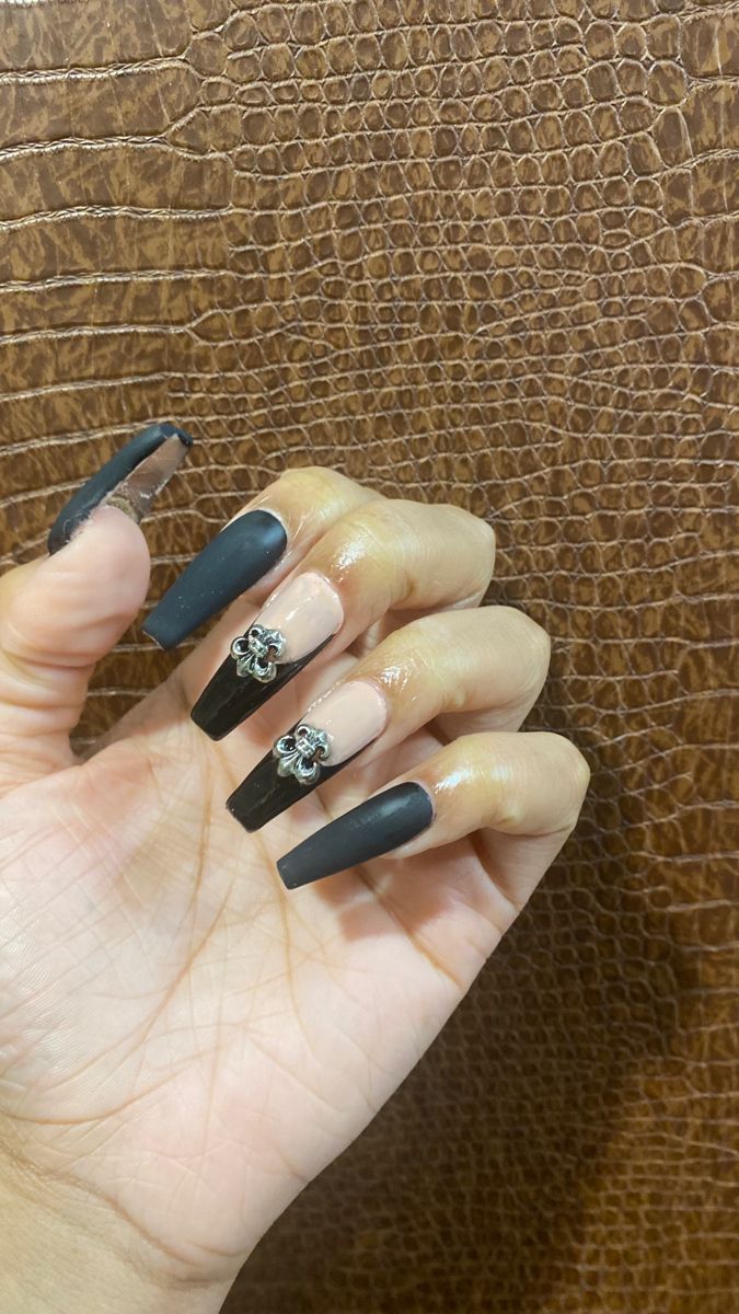 Sophisticated Matte Black and Nude Nail Design with Floral Charms for Any Occasion