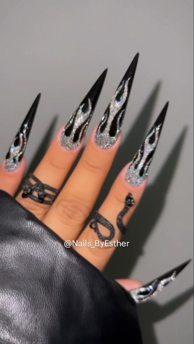 Edgy Bold Nail Design with Black Flames and Glittering Silver Backdrop