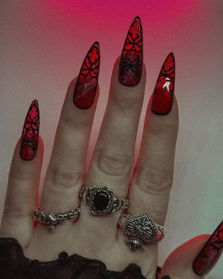 Gothic Elegance: Stunning Red Stiletto Nails with Black Lace and Silver Accents