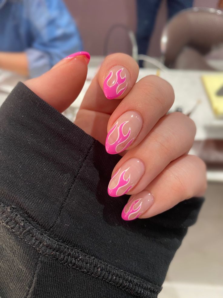 Bold Flame-Inspired Nail Design with Vibrant Pink and White Patterns on a Nude Base