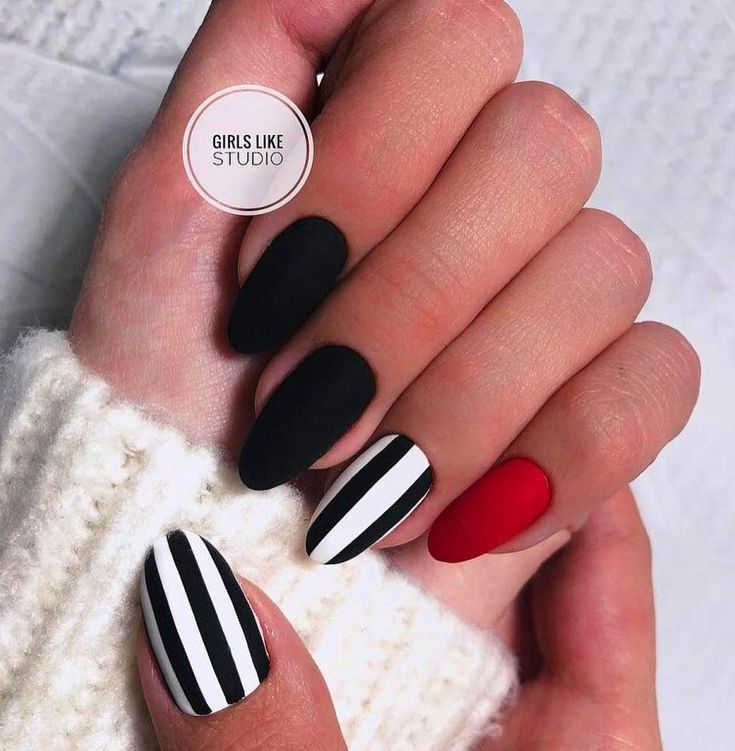 Chic Matte Black and Bold Red Nail Design with Striking Black-and-White Stripes.