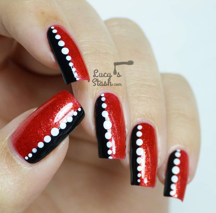 Edgy Red and Black Nail Design with Sparkly Gloss and Elegant White Dots.