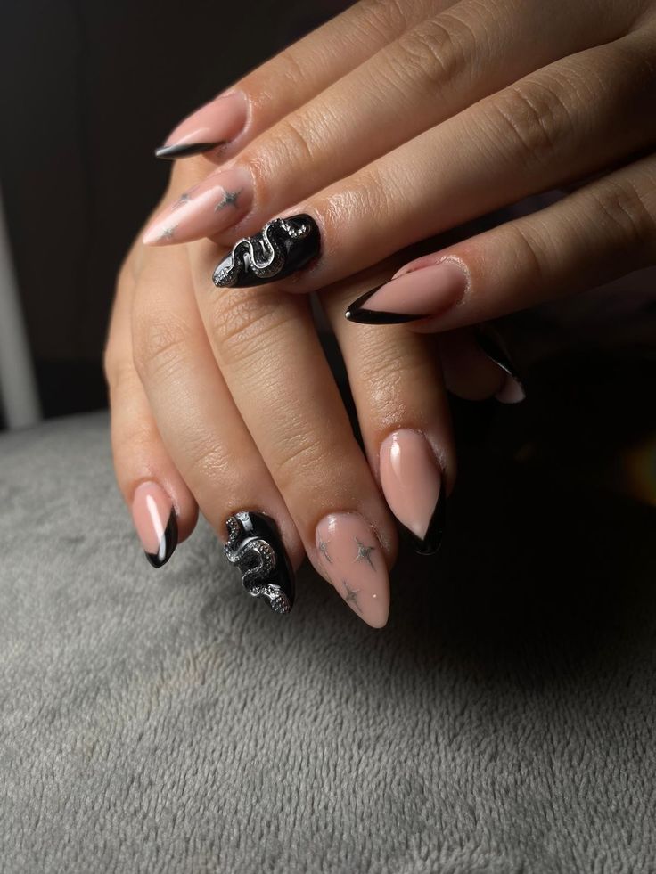 Chic Almond-Shaped Nail Design: Elegant Soft Pink and Bold Black with Snake and Star Accents.