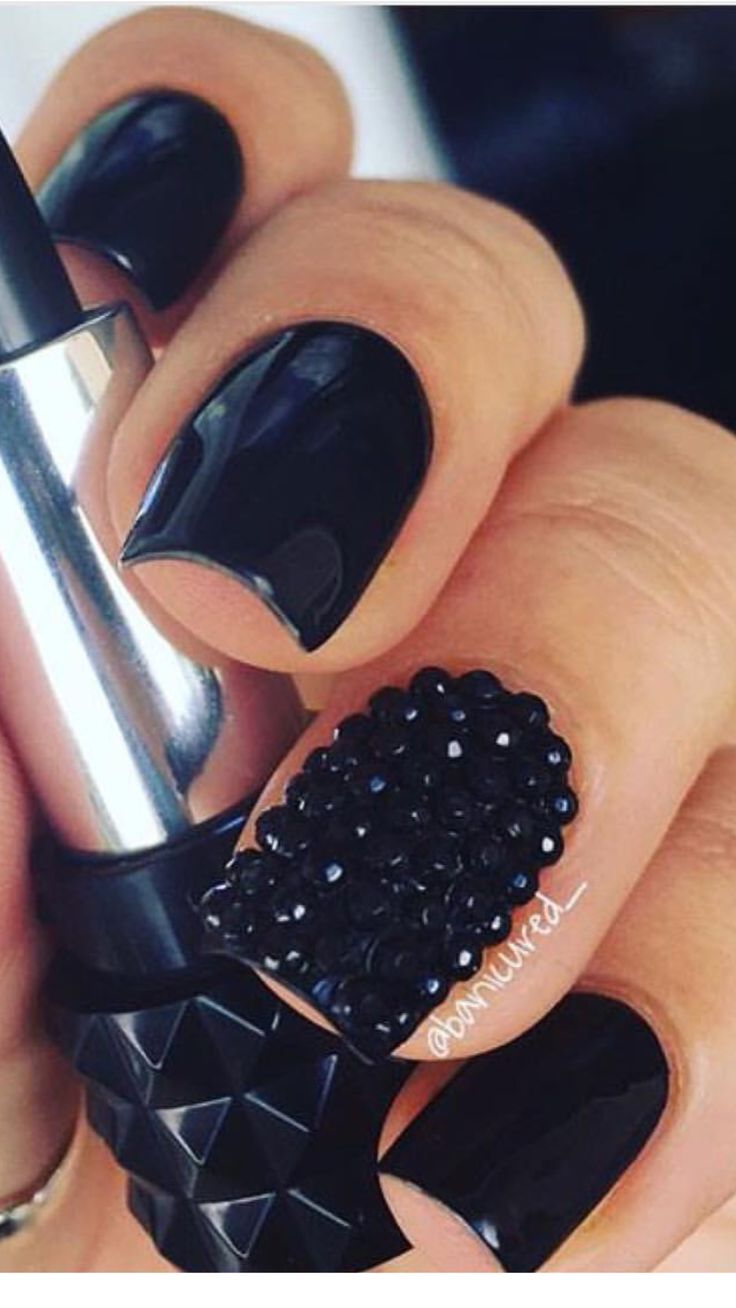 Sophisticated Black Nail Design: Glossy Finish, Matte Texture, and Rhinestone Accents.