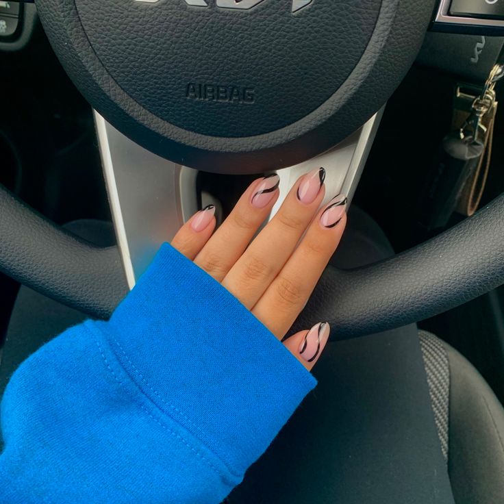 Chic Nail Design: Modern Soft Pink and Black Accents Paired with Cozy Blue Sweater.