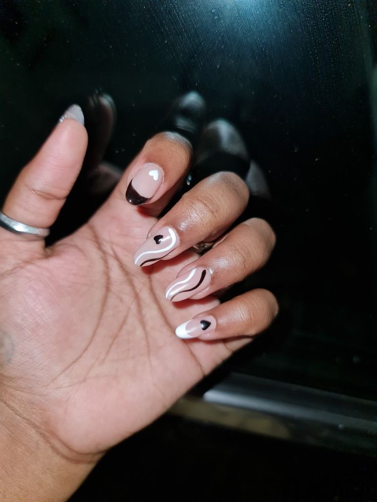 Chic Neutral and Black Nail Design with Elegant Swirls and Heart Motifs