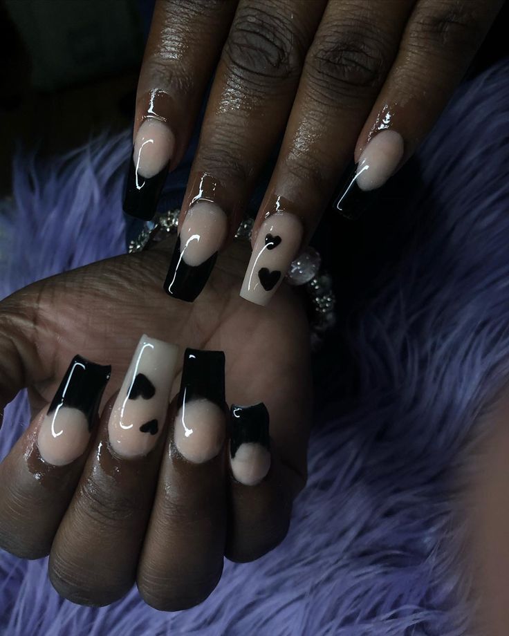 Chic Nude and Black Nail Design with Playful Heart Motif