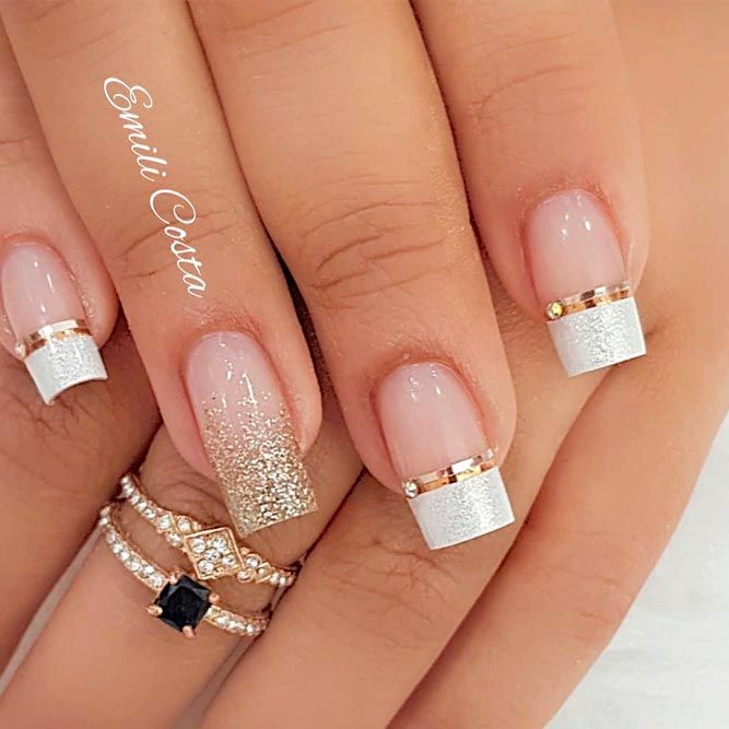 Chic and Sophisticated Nail Design with White and Gold Tips, Glitter Accents, and Elegant Gold Bands.