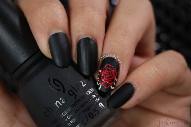 Elegant Matte Black Nails with Striking Red Rose Accent Design for a Sophisticated Look.