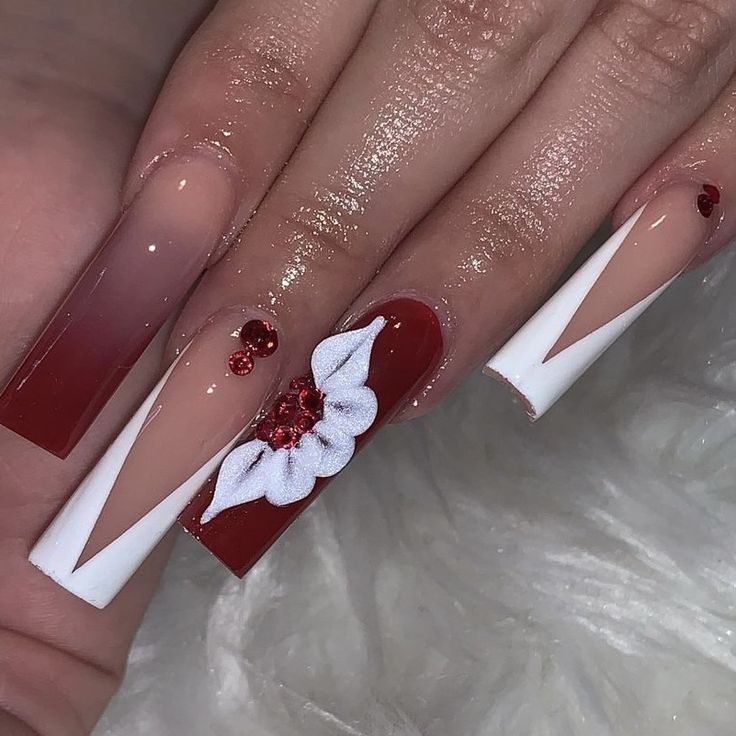 Sophisticated Red and White Gradient Nail Design with Geometric Patterns and Floral Accents.