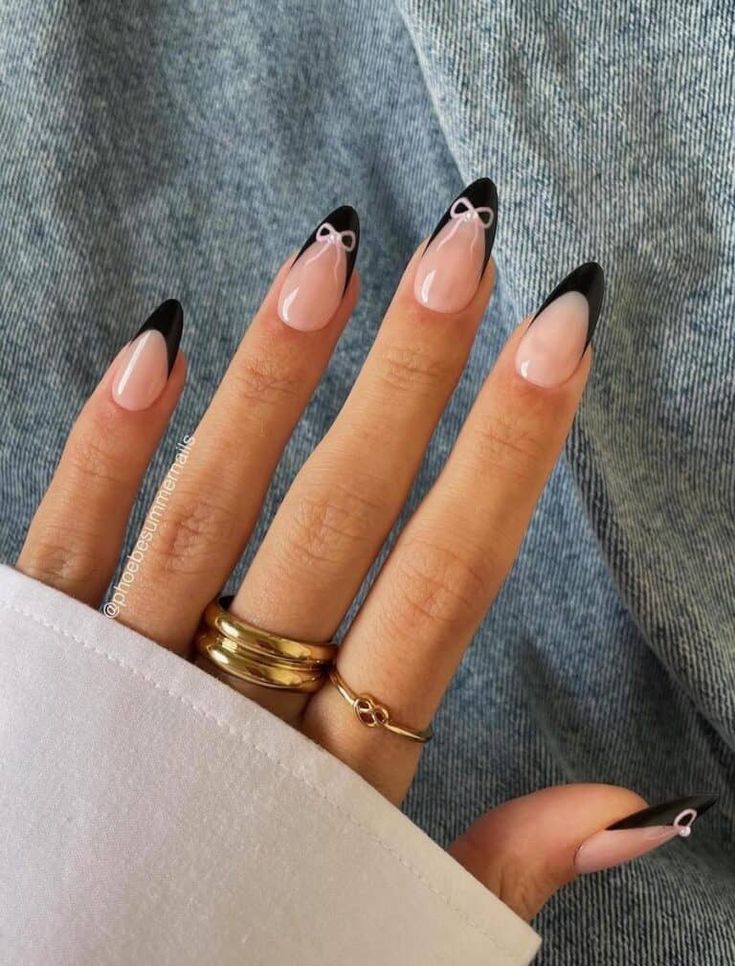 Chic Almond-Shaped Nails: Bold Black Tips and Playful White Bows.