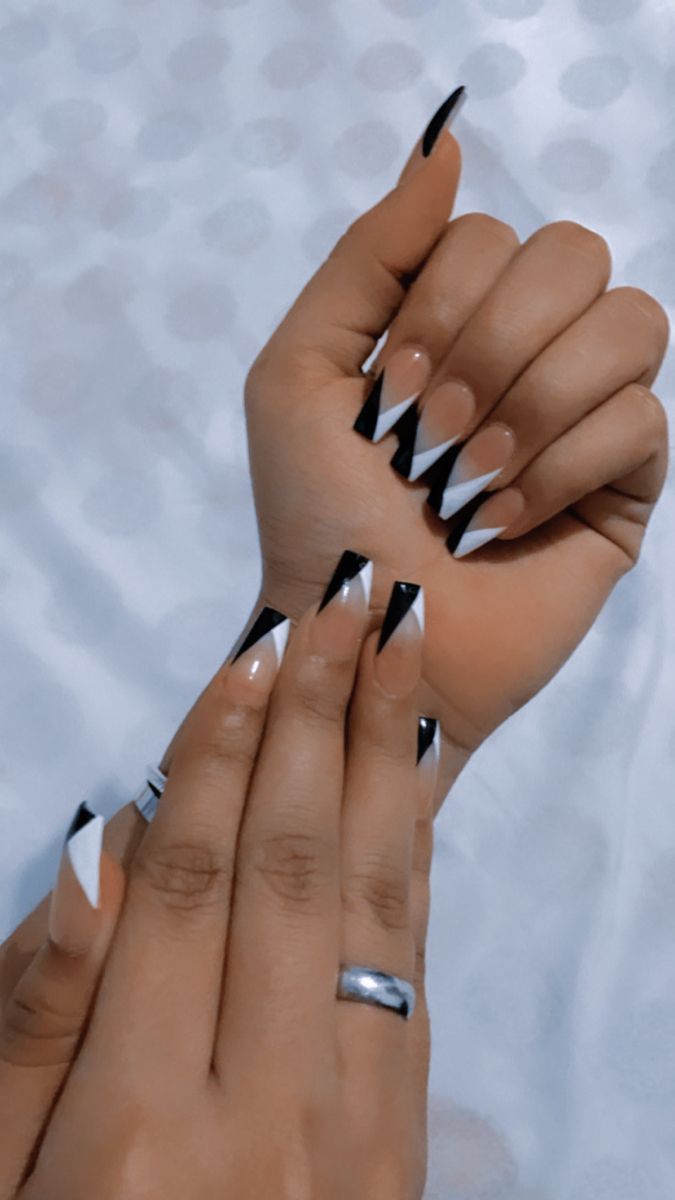 Bold Geometric Black, White, and Nude Nail Design with Elongated Tips.