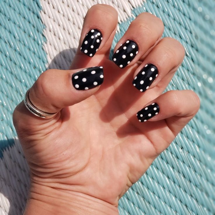 Chic Polka Dot Nail Design: Elegant Black Base with Vibrant White Dots