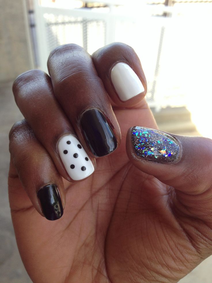 Chic Nail Design: Classic Meets Playful with Glossy Black, White Polka Dots, and Sparkly Accents