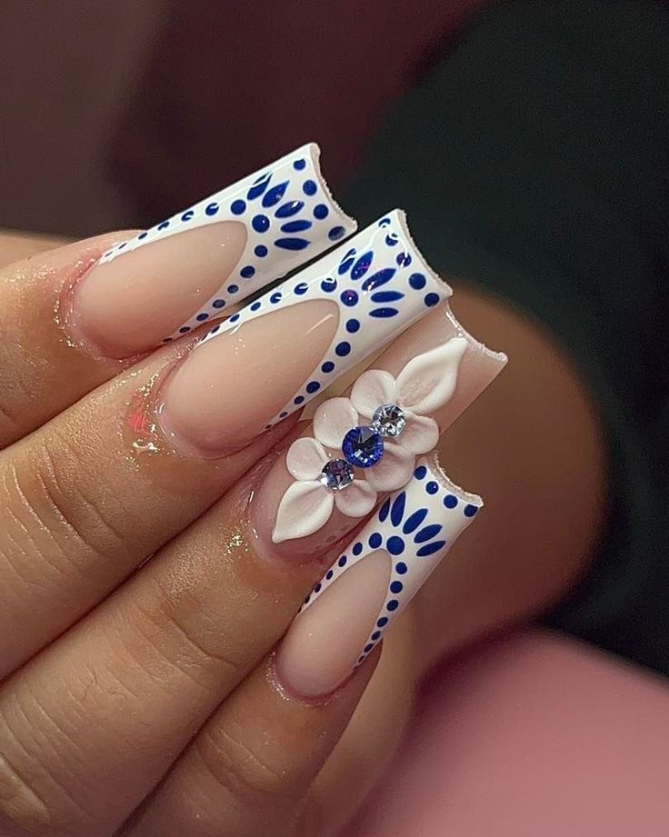 Chic Nail Design: Soft Pink Meets Striking Blue with Floral Accents and Modern Negative Space.