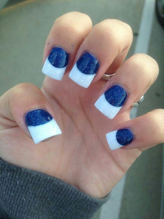 Striking Glossy Blue and White Nail Design with Glitter and Rounded Shapes.