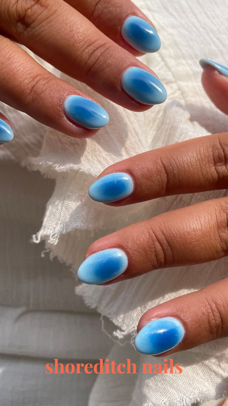 Elegant Ombre Nail Design with Soft Blue Gradient and Glossy Finish.