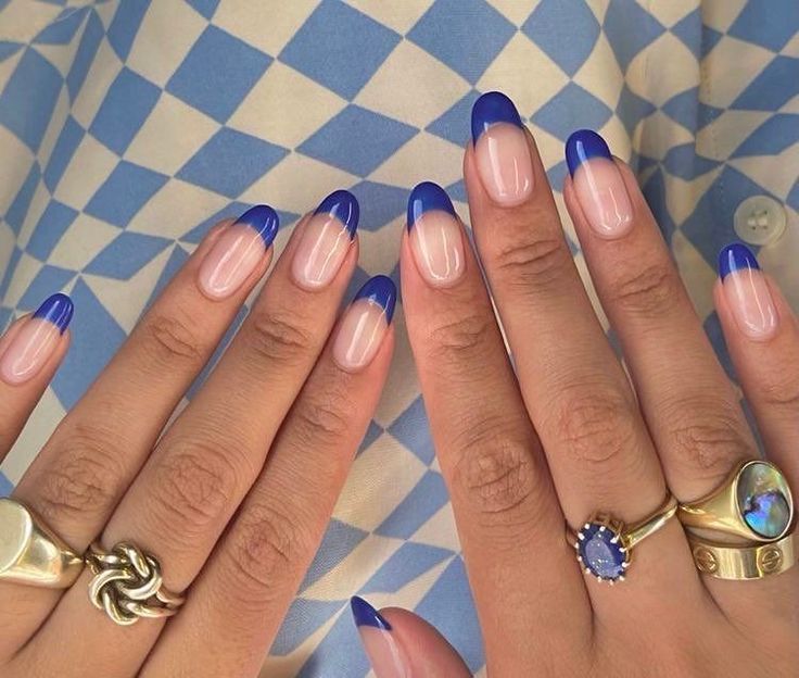 Modern Twist on Classic French Tip Nails with Vibrant Blue Tips and Elegant Accessories.