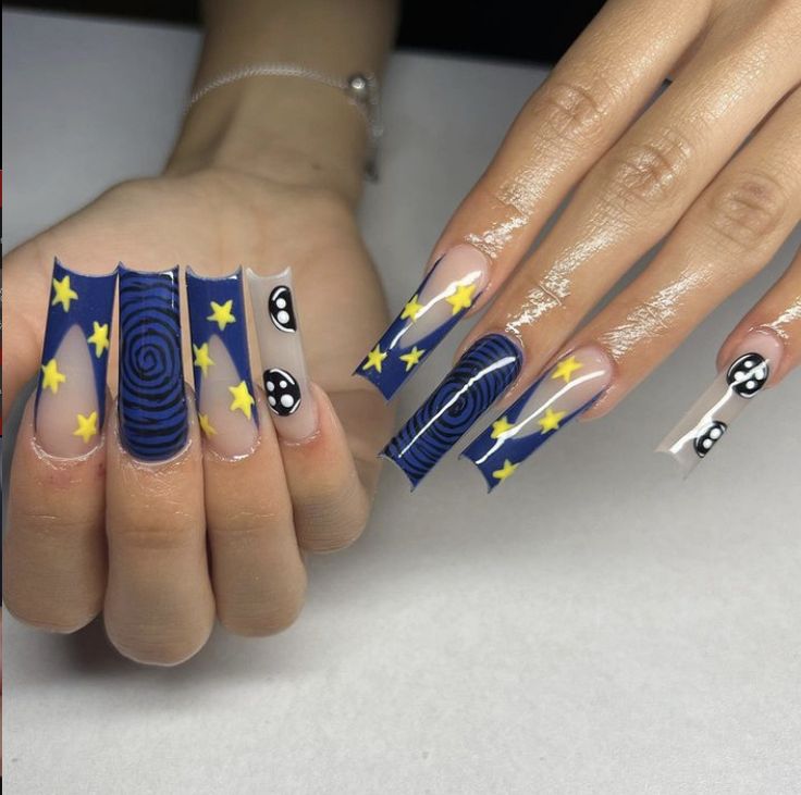 Whimsical Celestial Nail Design with Deep Blue, Clear Elements, Yellow Stars, and Contrasting Motifs.