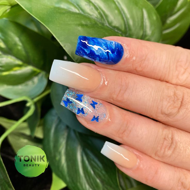 Bold Blue Marble Nail Design with Glossy Accents and Whimsical Star Embellishments