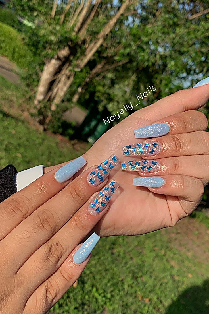 Whimsical Chic: Soft Blue Nail Design with Glittery Star Accents