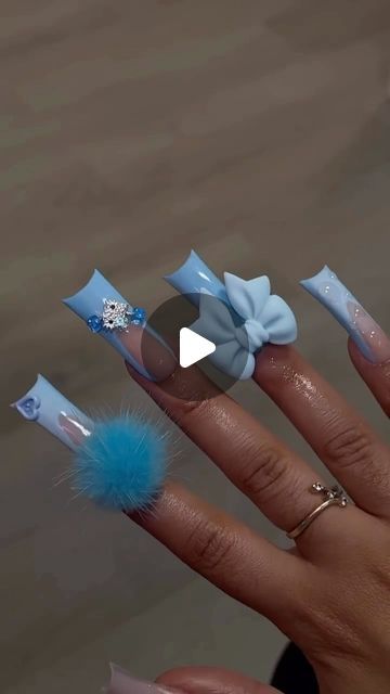 Whimsical Soft Blue Nail Design with Playful Embellishments