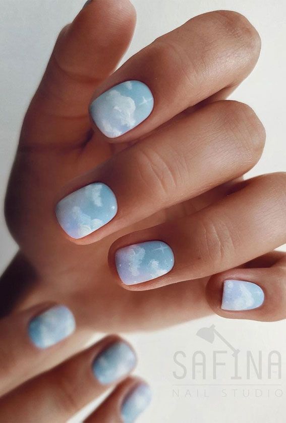 Serene Cloud-Inspired Nail Design with Dreamy Sky Blue Gradient and Fluffy White Clouds.