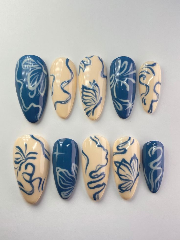 Elegantly Bold: Creamy Beige and Navy Blue Floral Nail Design