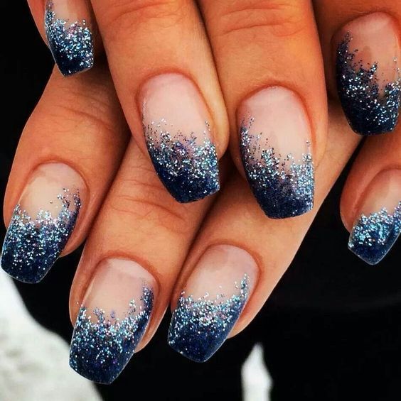 Striking Winter Ombre Nails: Deep Navy to Lighter Blue with Glitter Gradient