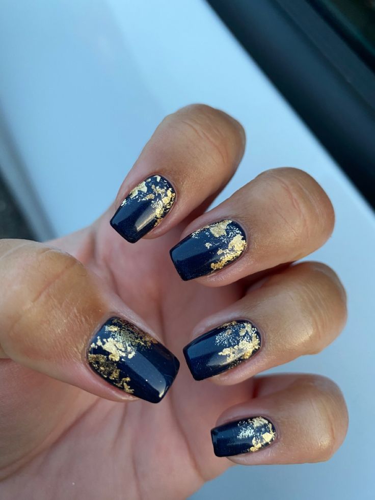 Elegant Dark Blue Nail Design with Glamorous Gold Foil Accents.