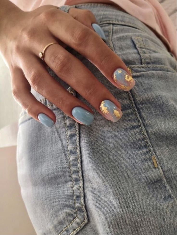 Elegant Soft Blue Nail Design with Cream and Gold Accents for a Chic Touch.