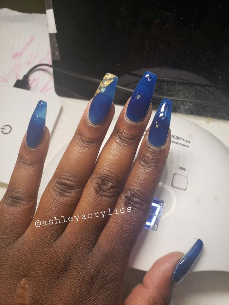 Chic Gradient Blue Nail Design with Gold Accents and Almond Shape.