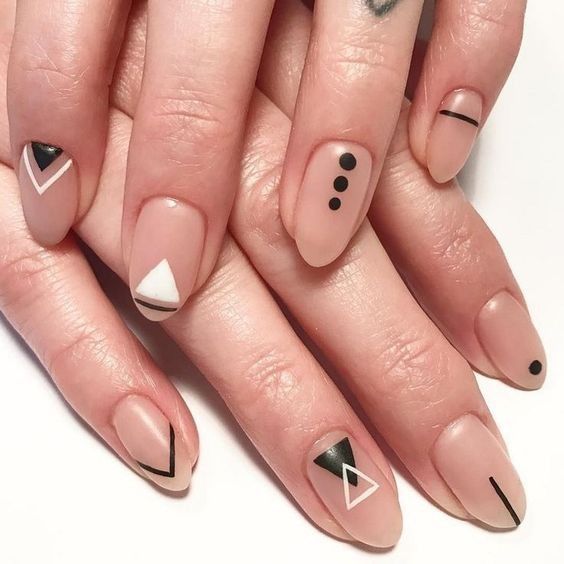 Chic Geometric Nail Design: A Modern Blend of Nude Base with Bold Black and White Shapes.