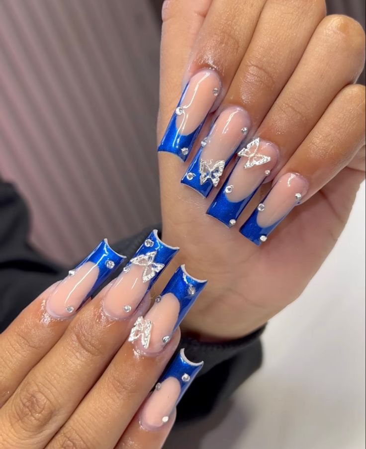 Chic Blue and Nude Nail Design with Bold Geometric Shapes and Glamorous Embellishments.