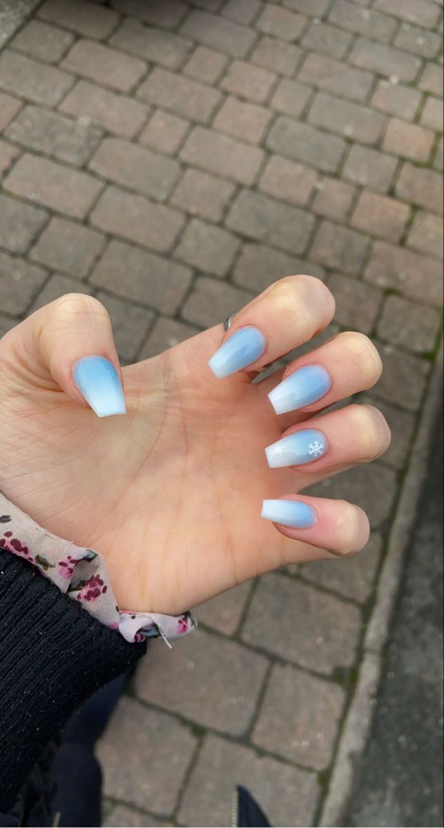 Charming Winter Ombre Nails with Soft Blue Gradient and Snowflake Accent.